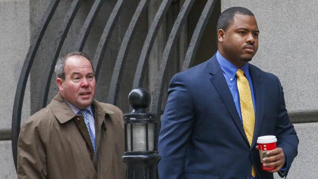 Baltimore Police Officer William Porter, right, approaches the courthouse in Baltimore, Maryland, Nov. 30, 2015. Porter is one of six Baltimore police officers charged in connection with the death of Freddie Gray. 