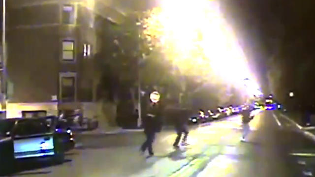 In this frame grab made from an Oct. 12, 2014, video released by the Chicago Police Department, Ronald Johnson, right, is seen running from police officers just a second before he was shot by an officer. 