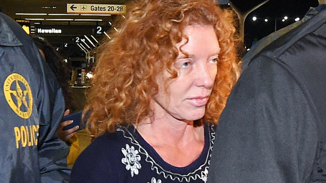 Tonya Couch is taken by authorities to a waiting car after arriving at Los Angeles International Airport Dec. 31, 2015, in Los Angeles. 