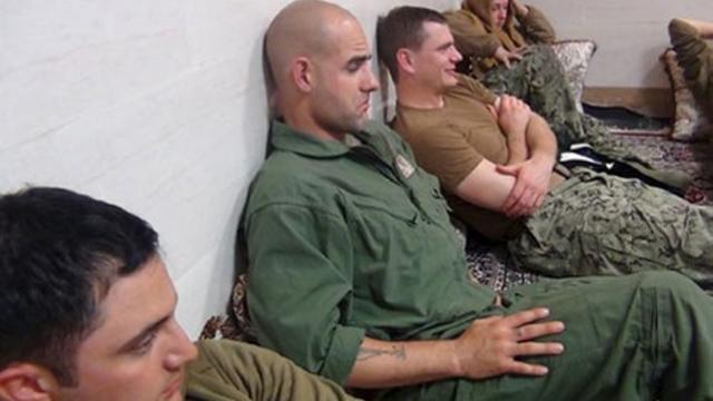 An undated picture released by Iran's Revolutionary Guards website shows American sailors sitting in a unknown place in Iran. 