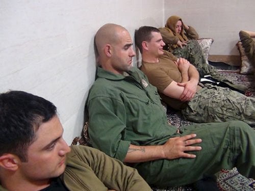 An undated picture released by Iran's Revolutionary Guards website shows American sailors sitting in a unknown place in Iran. 