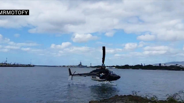 ​A helicopter crash-lands in the water near Pearl Harbor in Hawaii Feb. 18, 2016, in this still from a video posted by YouTube user mrmotofy. 