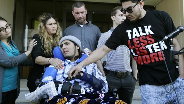 Alex Lemus, right, grasps his brother Sergio Molina's hand, front, as they gather with their mother Maria Lemus, center left, Tim McLaughlin, center, and his son Isaiah McLaughlin after a juvenile court hearing for Ethan Couch Feb. 19, 2016, in Fort Worth, Texas. Sergio Molina and Isaiah McLaughlin were injured in an accident caused by Couch. 