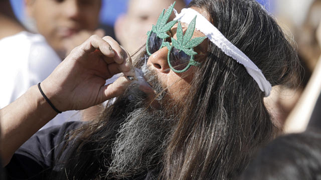 Fast Eddy Aki'a of Hawaii smokes a joint as thousands gathered to celebrate the state's medicinal marijuana laws and collectively light up at 4:20 p.m. in Civic Center Park April 20, 2012, in Denver, Colorado. 