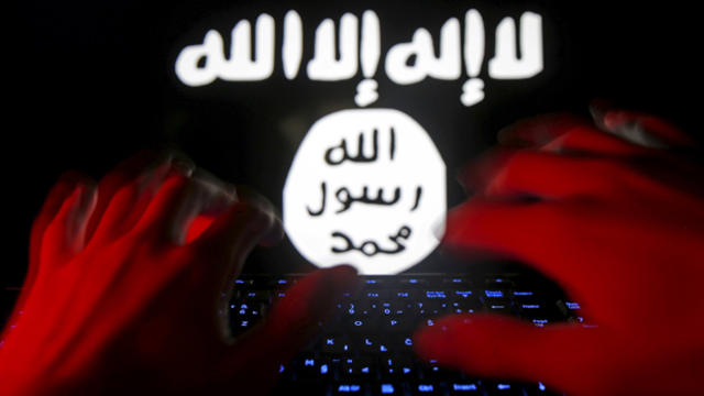 ​A man types on a keyboard in front of a computer screen on which an Islamic State of Iraq and Syria flag is displayed in this picture illustration taken in Zenica, Bosnia and Herzegovina, Feb. 6, 2016. 