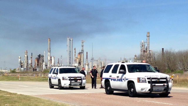 ​Police officers stand on a road in front of a refinery where a generator exploded in Pasadena, Texas, March 5, 2016. 