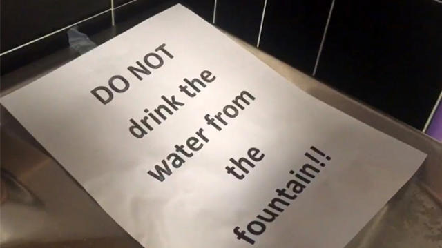 ​A sign advises people not to drink from a water fountain at Newark Vocational Schools in Newark, New Jersey, March 9, 2016. 