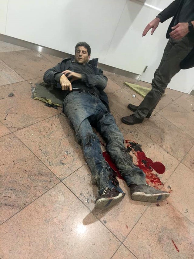Wounded Belgian basketball player Sebastien Bellin lies on the ground in Zaventem Bruxelles International Airport in Brussels after explosions ripped through the departure hall on March 22, 2016.