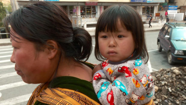bhutan-bhutanese-mother-carrying-child-on-back.jpg 