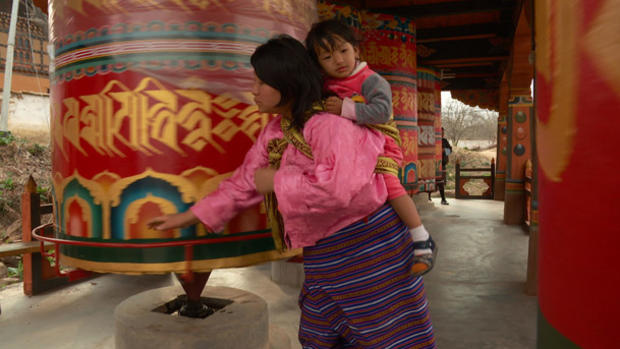 bhutan-bhutanese-mother-and-child-at-prayer-wheel-wide.jpg 