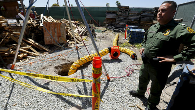 ​U.S. Border Patrol officer Cesar J. Sotelo stands guard over a hole in the ground after the discovery of a cross-border tunnel from Tijuana, Mexico, to San Diego, California, April 20, 2016. 