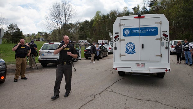 Authorities allow crime scene investigation vehicles to pass a perimeter checkpoint near a crime scene April 22, 2016, in Pike County, Ohio. 