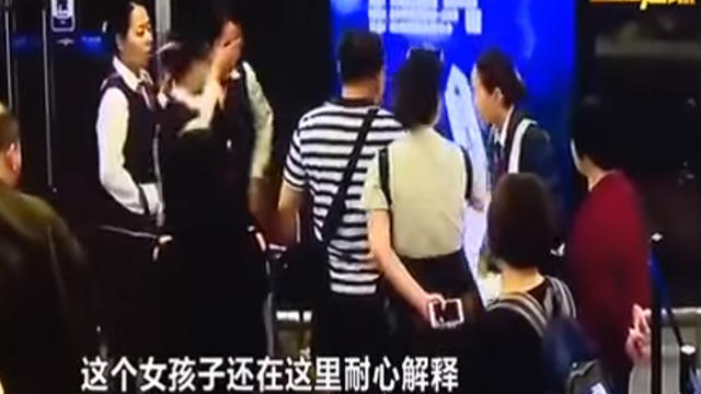 ​Staff at the Changsha airport in China (left) comfort a colleague after she was hit the face by objects thrown by irate airline passengers 