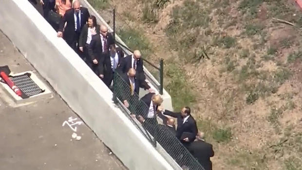 Donald ​Trump hops a wall to reach the Hyatt Regency hotel in Burlingame, California, on April 29, 2016. 
