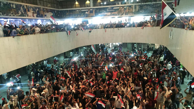 ​Followers of Iraq's Shiite cleric Muqtada al-Sadr are seen in the parliament building as they storm Baghdad's Green Zone after lawmakers failed to convene for a vote on overhauling the government in Iraq April 30, 2016. 