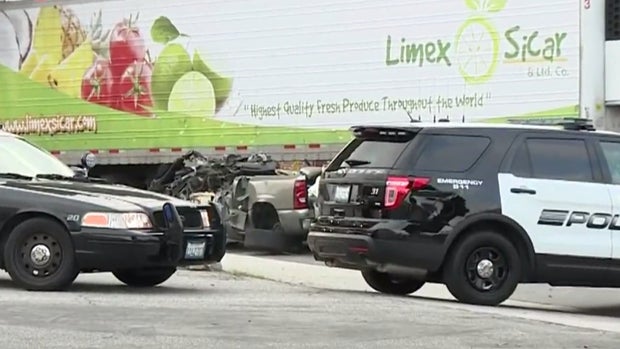 A pickup truck lies beneath a tractor-trailer after it was hit by the 18-wheeler on April 30, 2016, in Vernon, California. 
