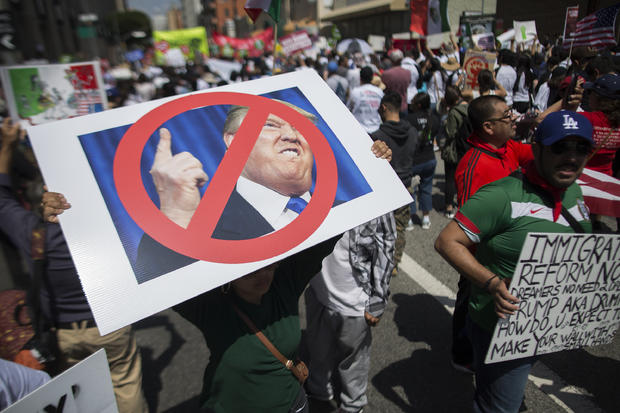 Woman carries placard critical of Donald Trump during May Day march in Los Angeles onMay 1, 2016 