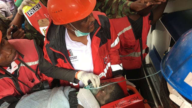 A woman is rescued from the rubble of a six-story building that collapsed in Nairobi, Kenya, May 5, 2016. 