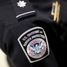 A U.S. Customs and Border Protection officer's patch is seen as the agency unveils a new mobile app for international travelers arriving at Miami International Airport on March 4, 2015, in Miami, Florida. 