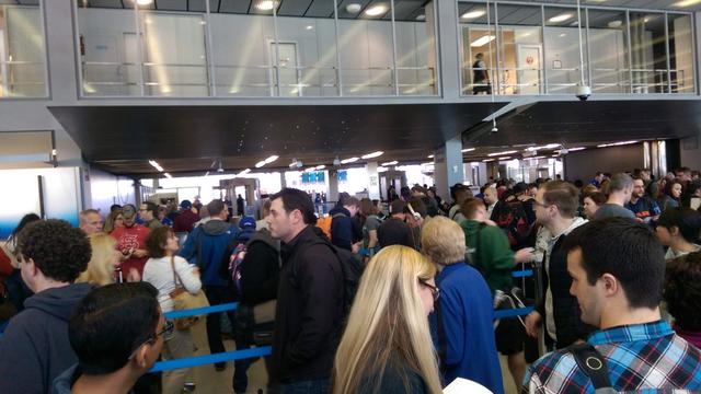 ​Travelers at Chicago O'Hare International Airport gather after a fire at a FAA facility led to a ground stop of all flights in and out of Chicago's airports. 