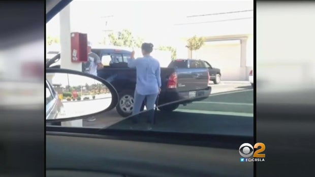 ​A woman counts down before hitting a man's pickup truck with a bat in Lancaster, California, in cellphone video broadcast on CBS Los Angeles on May 18, 2016. 