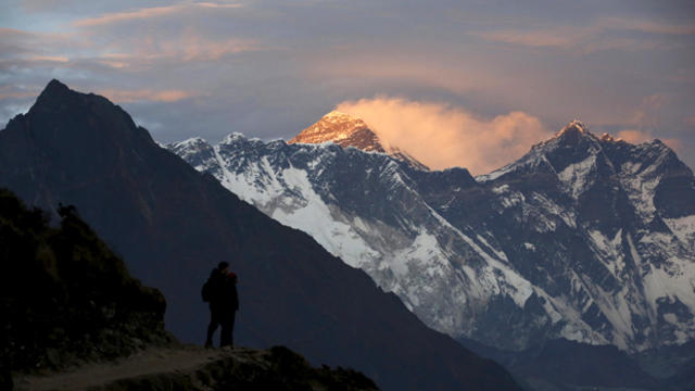 ​Light illuminates Mount Everest during sunset in Solukhumbu district, Nepal, also known as the Everest region, on Nov. 30, 2015. 