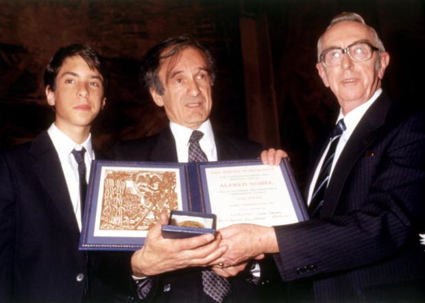 Elie Wiesel, center, his son Elisha, left, and Nobel Peace Prize Committee chairman Egil Aarvik display Wiesel's Nobel Peace Prize during the awarding ceremony Dec. 10, 1986, in Oslo. 
