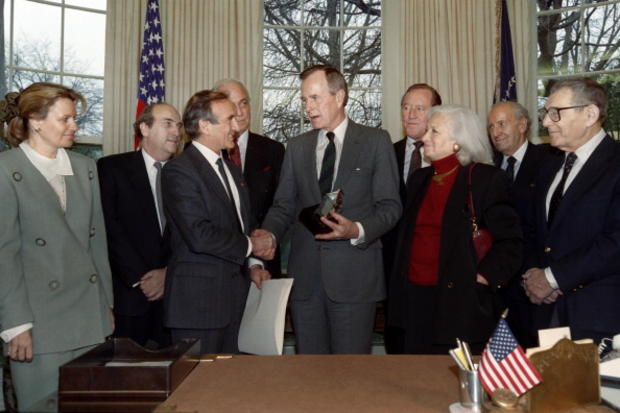 President George H. W. Bush receives the Elie Wiesel Foundation Humanity Award on March 18, 1991, in the Oval Office of the White House from Nobel laureate Elie Wiesel. 