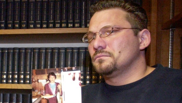 Brian Gergely holds up an old photograph of himself while discussing a lawsuit against a priest and the Roman Catholic Diocese of Altoona-Johnstown, during a news conference in Altoona, Pennsylvania, on Feb. 6, 2003. 