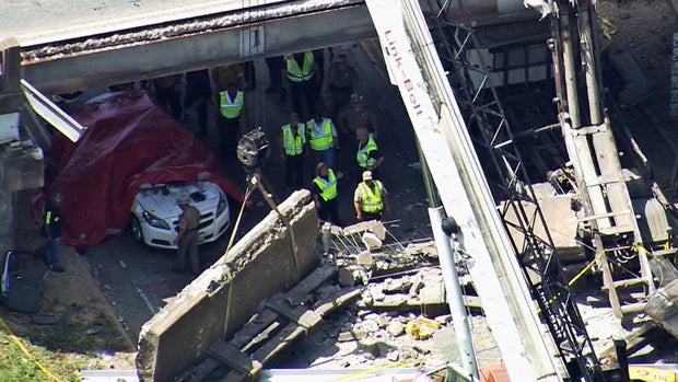 ​Crews work the scene after a highway overpass collapsed in Sealy, Texas, on July 7, 2016. 