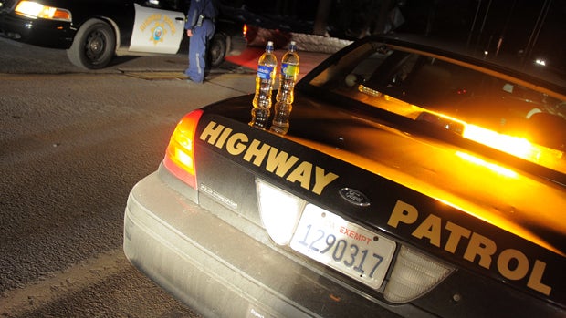 California Highway Patrol officers confer at a roadblock on Highway 38 near Angeles Oaks during a standoff with fugitive ex-cop Christopher Dorner, near San Bernardino, California, on Feb. 12, 2013. 