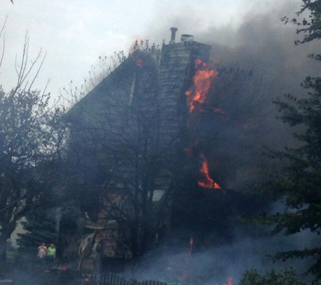 ​Crews work the scene after a small plane crashed into a house in Plainfield, Illinois, on July 21, 2016. 