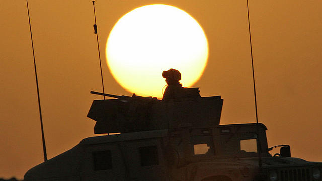 A humvee filled with U.S. Marines conducting a mounted combat patrol cruises through the desert during sunset near Al-Asad, Iraq, on June 15, 2006, in a picture released by the Marines. 