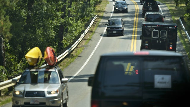 President Obama's motorcade makes its way along island roads to the beach Aug. 18, 2015, in Edgartown, Massachusetts, on Martha's Vineyard. 