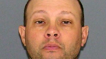 Indianapolis police officer ​Adrian Aurs is seen in an undated booking photo obtained by CBS Indianapolis affiliate WTTV. 