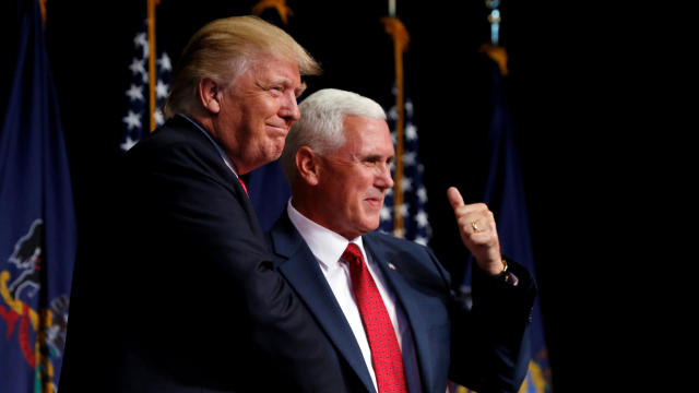 ​Republican presidential nominee Donald Trump shakes hands with vice presidential nominee Mike Pence at a campaign rally in Scranton, Pennsylvania, July 27, 2016. 