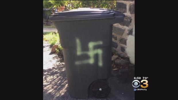swastika on woman's trashcan 