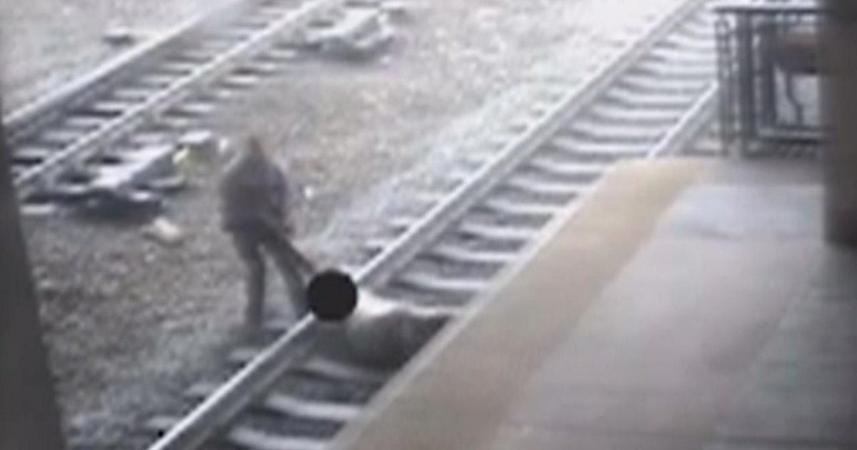 N.J. officer saves man from tracks seconds before train arrives - CBS News
