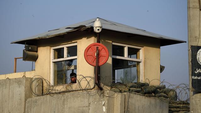 An Afghan security keep watch from a guard tower of the American University compound after the militants’ raid that targeted the elite American University of Afghanistan 