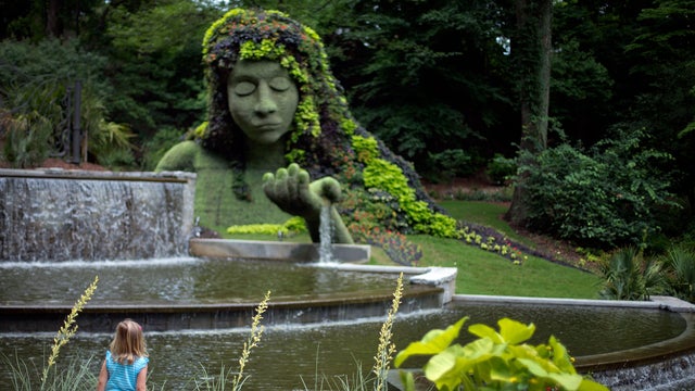 Caroline Hill, 5, of Atlanta, stops in front of the &ldquo;Earth Goddess&rdquo; mosaiculture plant installation on display at the Atlanta Botanical Gardens June 7, 2013, in Atlanta. 