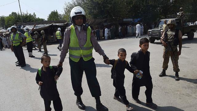 Pakistani soldiers cordon off a street leading to the Christian colony following an attack by suicide bombers 