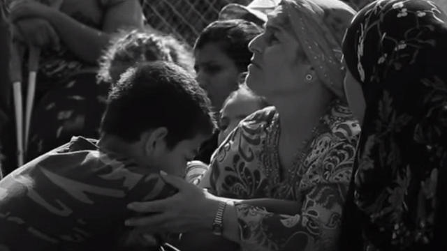 Mustafa, at left, is seen with his mother at a holding camp for refugees in Greece 