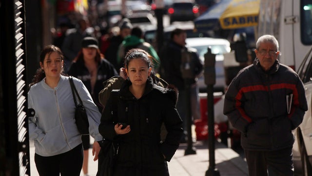 Hispanic residents walk down a street on March 28, 2011, in Union City, New Jersey. 