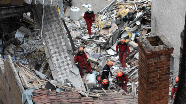 French firefighters work in the rubble on Pierre Palliot Street in Dijon, France, after a gas explosion destroyed a building on Sept. 16, 2016. 