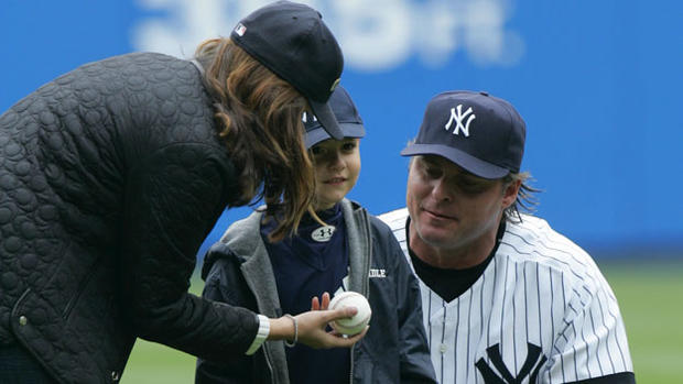 Melanie Lidle, widow of the late Corey Lidle, hands a ball t 