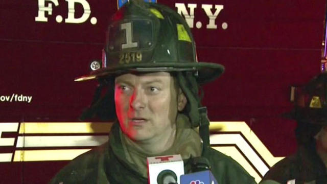 New York City Firefighter Jim Lee speaks to reporters after saving a man from a building fire on the Upper East Side of the Manhattan borough of New York on Oct. 27, 2016. 