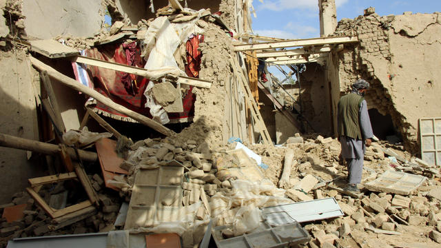 An Afghan man inspects a house destroyed during an airstrike called in to protect Afghan and U.S. forces during a raid on suspected Taliban militants in Kunduz, Afghanistan, Nov. 4, 2016. 