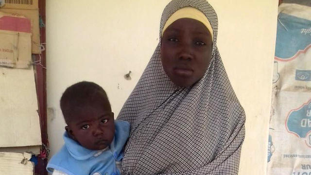 A Chibok schoolgirl is seen with her baby in a photo obtained by CBS News after they were rescued from Boko Haram extremists in Nigeria on Nov. 5, 2016. 