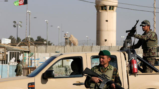 Afghan National Army soldiers keep watch outside the Bagram Airfield entrance gate after an explosion at the NATO air base north of Kabul, Afghanistan, Nov. 12, 2016. 