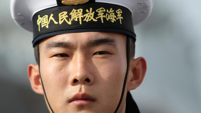 A Chinese sailor stands guard on a Chinese navy frigate called Yancheng in San Diego on Dec. 6, 2016, during a four-day visit to California. 